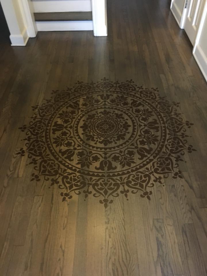Wooden floor with a decorative mandala stenciled on